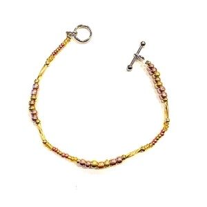 Gold, bronze, and silver bracelet
